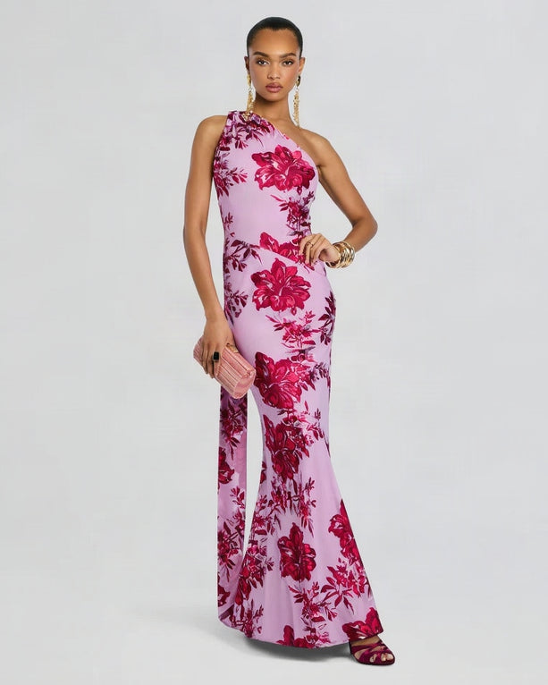 Woman wearing a pink floral one-shoulder dress on a white background