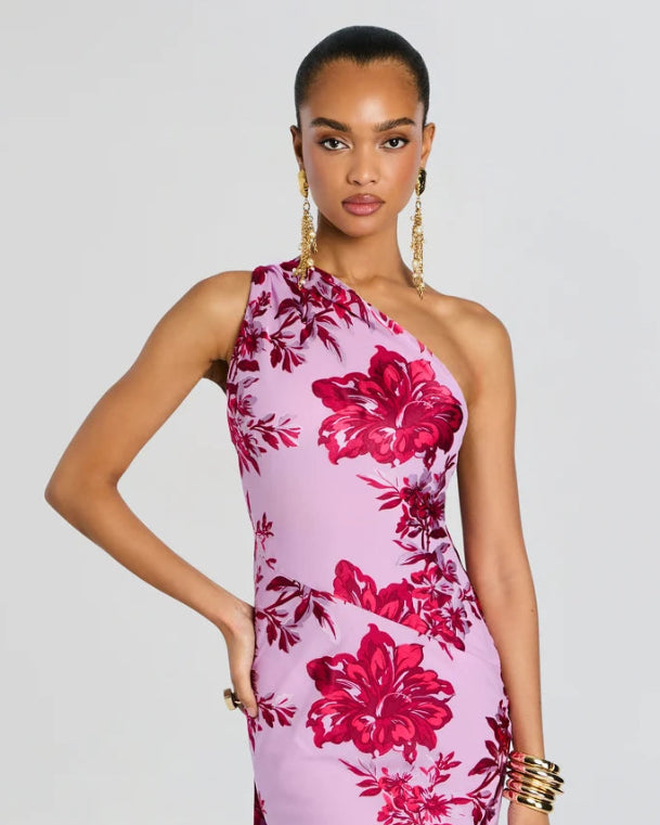 Woman wearing a pink floral dress against a gray background